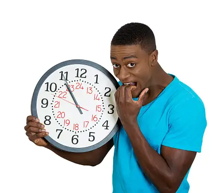 A young man holding a clock